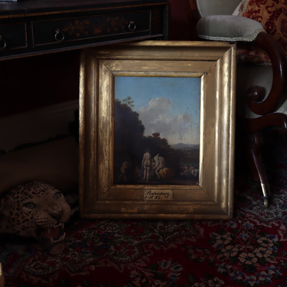 A 17th-century oil painting depicting classical bathing figures in an Arcadian landscape, framed in a heavy giltwood frame with a nameplate. View II