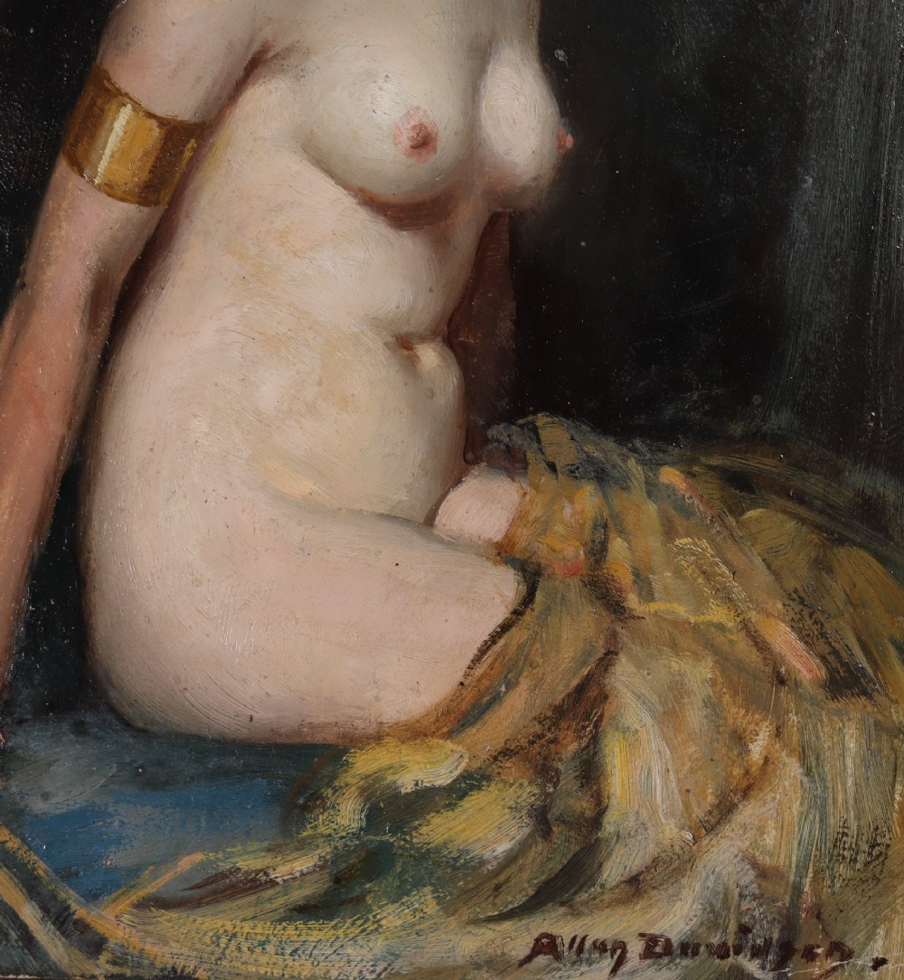 An oil painting on board depicting a seated female nude in profile wearing gold jewellery, presented in a painted cream and gold wood frame. View III