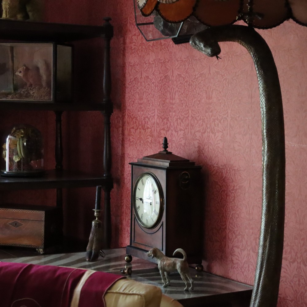 A George IV mahogany bracket clock featuring ebony inlaid lines, brass ball feet, side carrying handles, and a circular white dial signed by L. Vick of Stroud. View VII