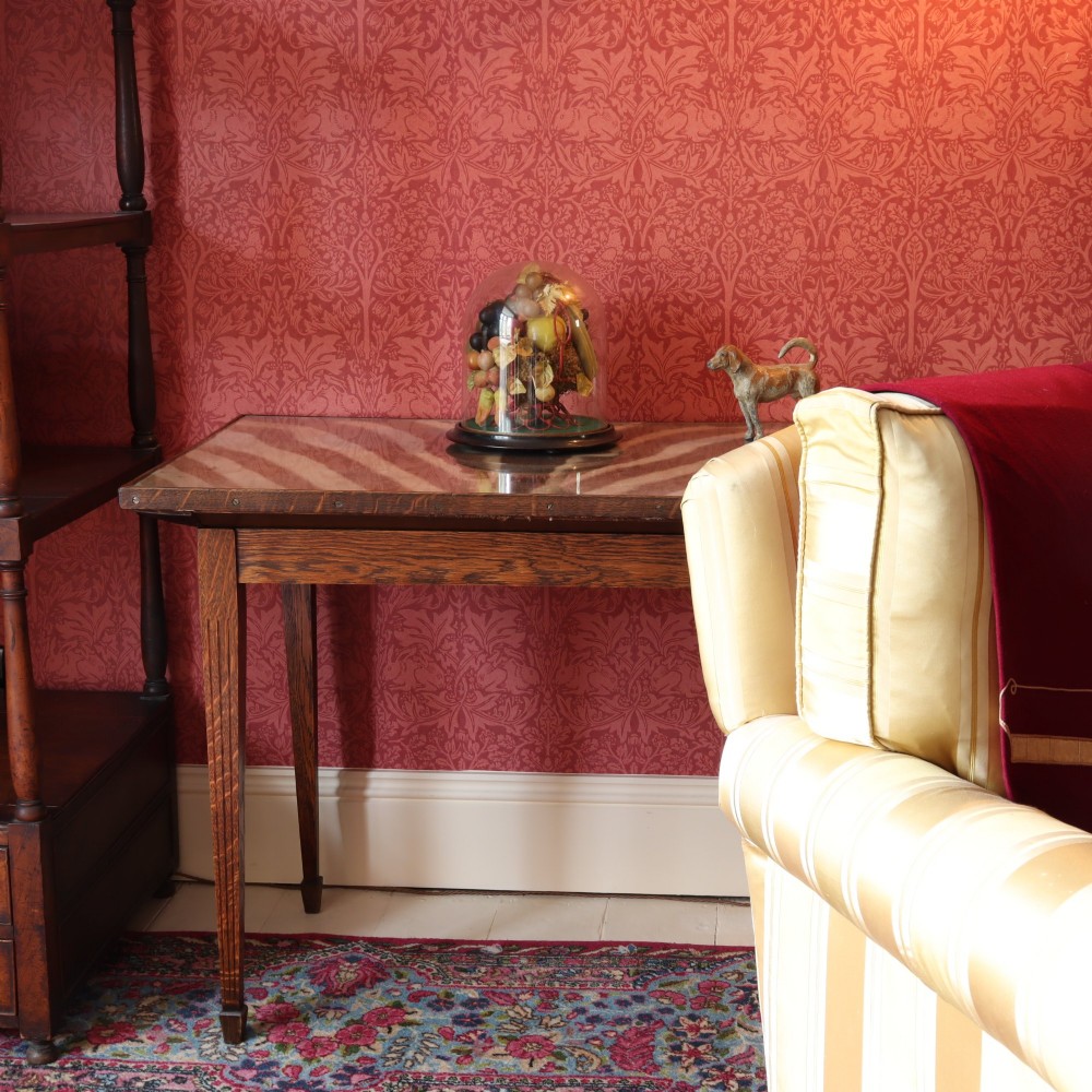 A rectangular oak occasional table featuring a zebra hide inset top protected by glass, supported by four tapered square legs. View II