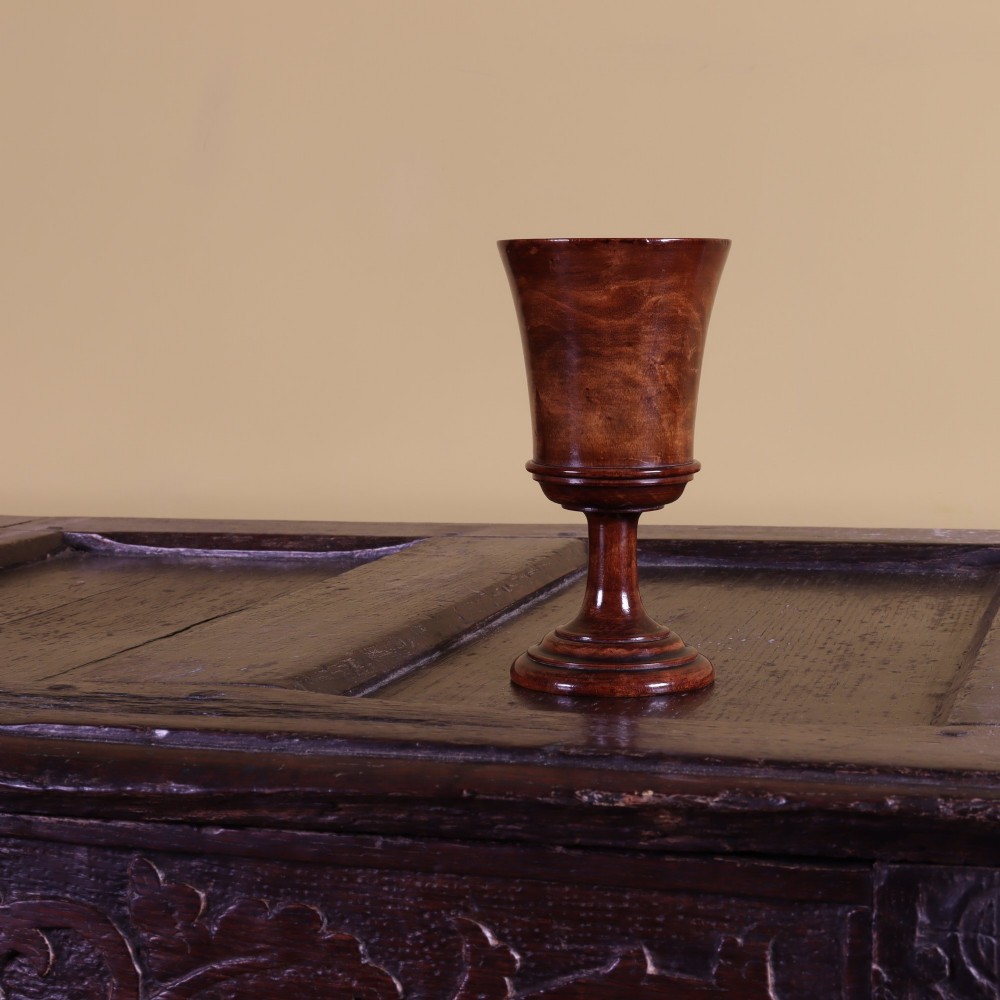 A turned wooden pedestal goblet featuring a wide flared lip, a moulded waist ring, a slender stem, and a stepped circular foot. View II