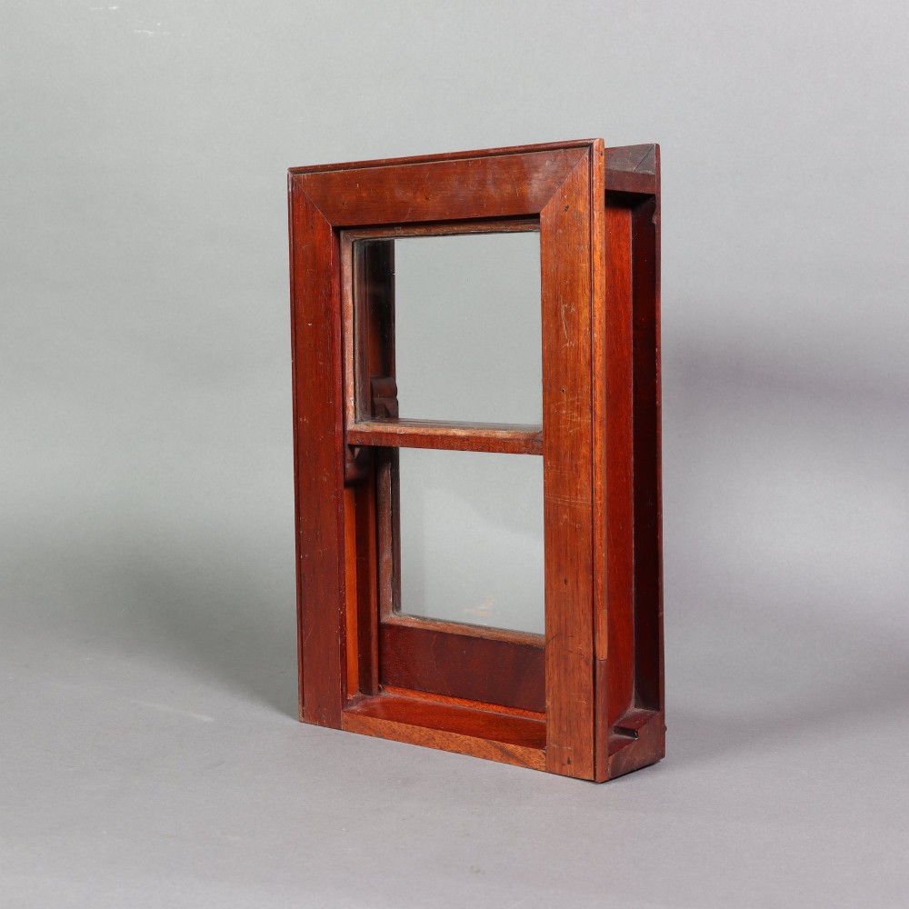 A 19th-century miniature mahogany sash window model featuring glazed panes and a polished timber frame. View V