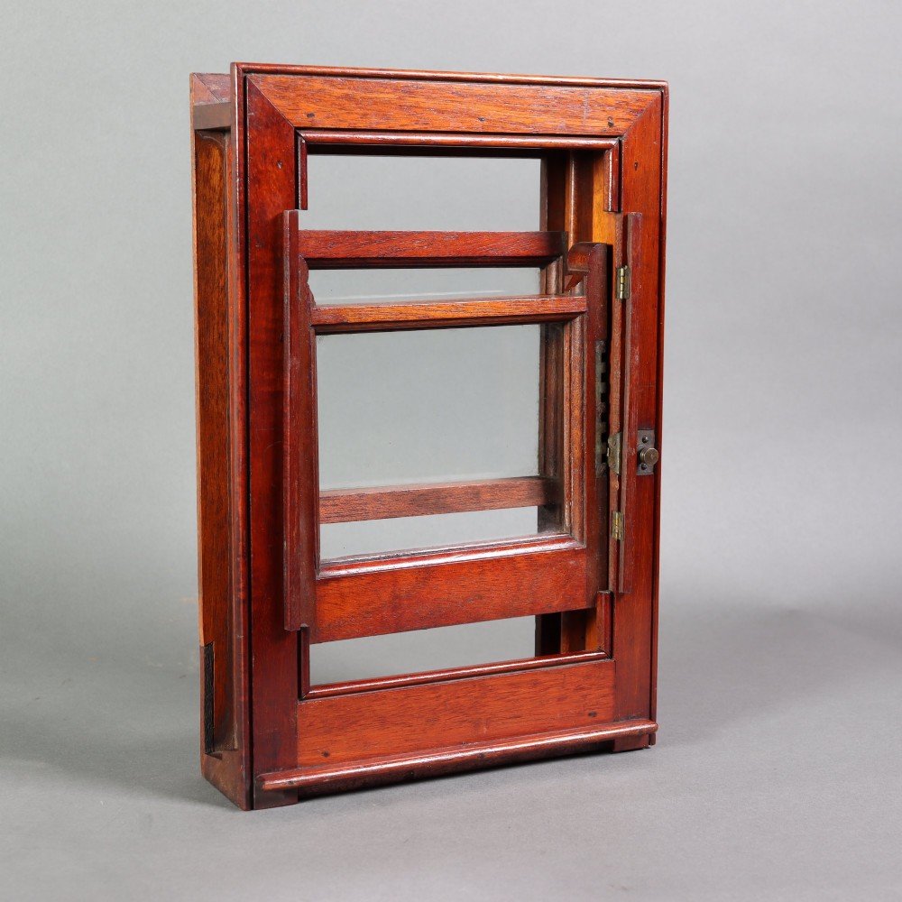 A 19th-century miniature mahogany sash window model featuring glazed panes and a polished timber frame. View VI