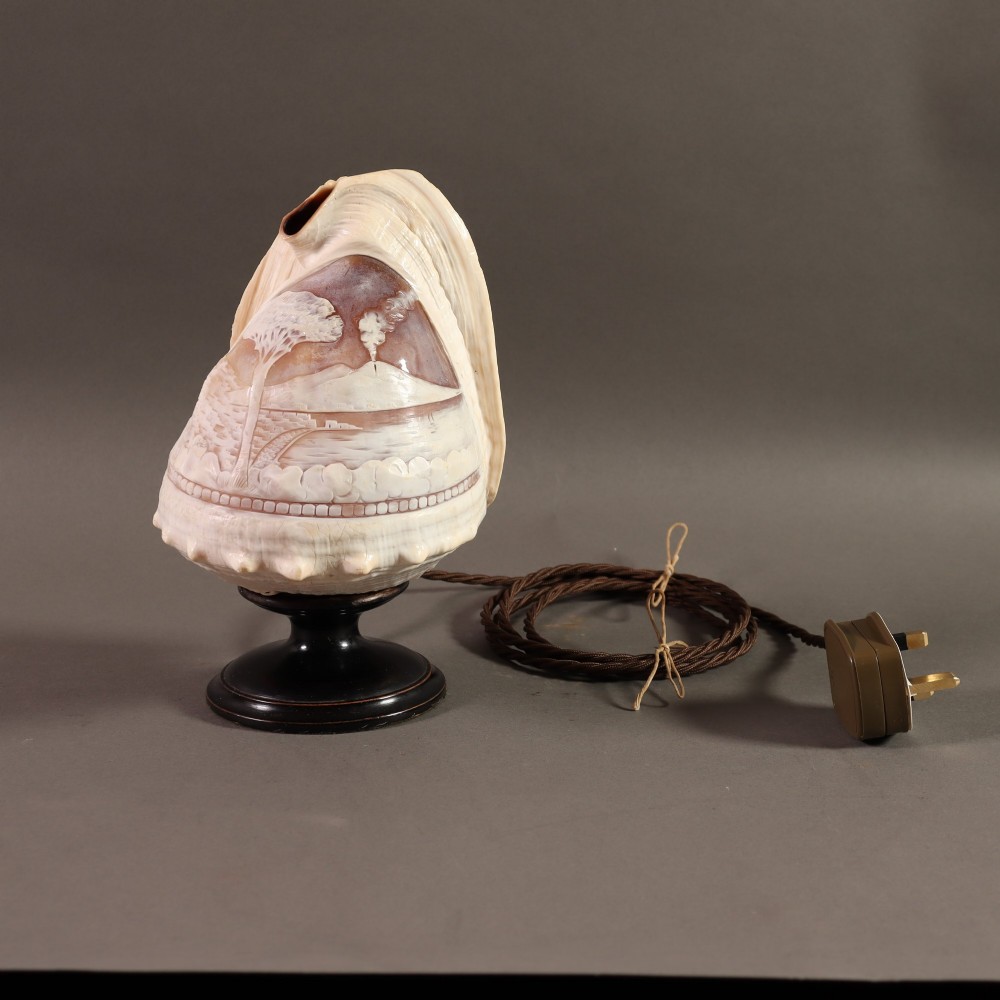 An illuminated 19th-century conch shell carved in relief with a scene depicting Mount Vesuvius, mounted on a turned ebonised wood base. View III