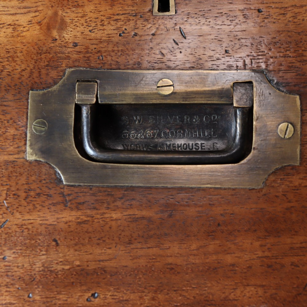 A Victorian mahogany two-part military campaign chest of drawers featuring recessed brass handles, corner brackets, side carrying handles, and short turned feet. View IV