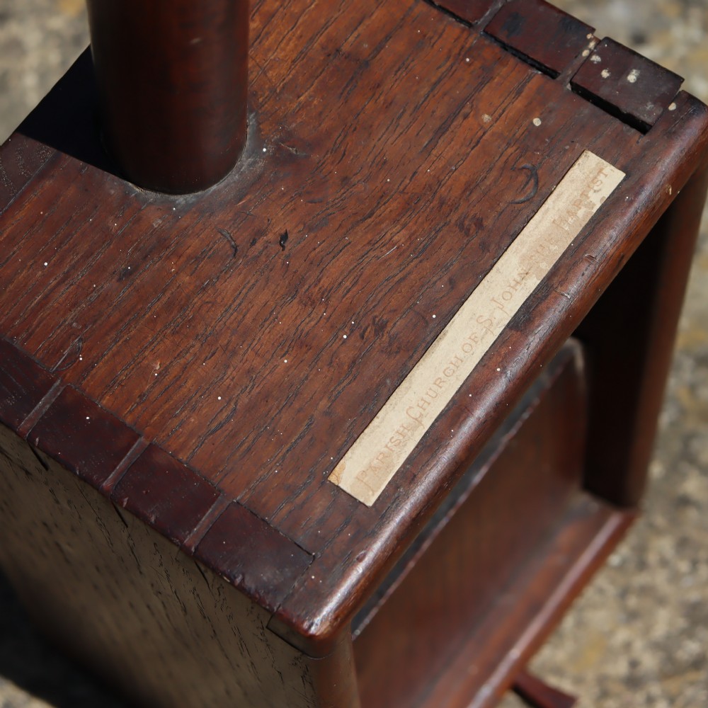 An antique long-handled dark wooden church collection box with a turned pole and a rectangular open container at the end. View II