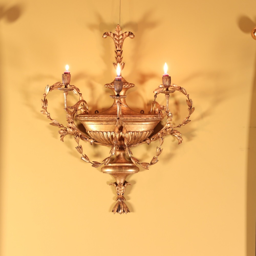 A George III giltwood and gesso three branch wall sconce