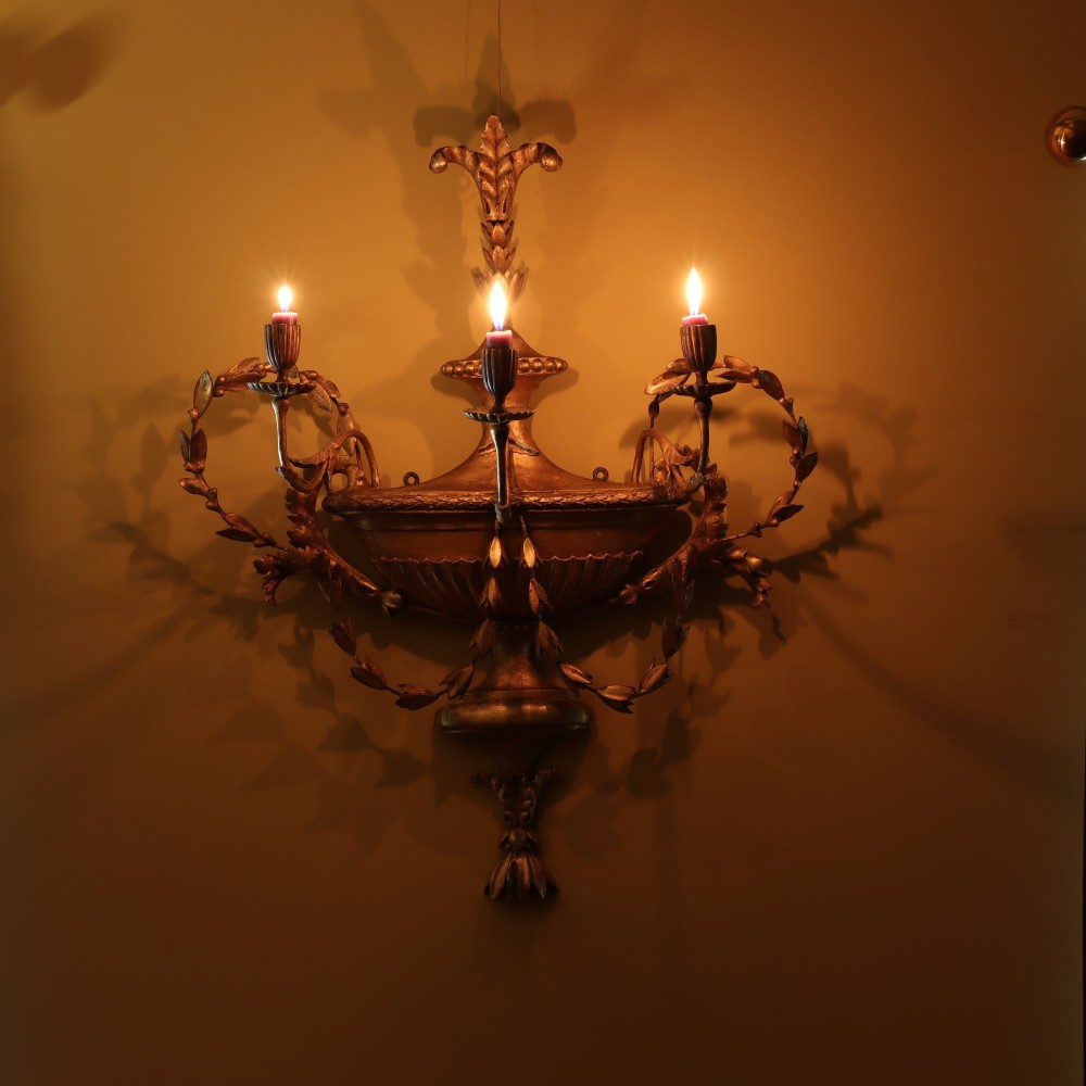 A George III style carved giltwood three-branch wall sconce featuring a central fluted urn motif flanked by scrolling foliate arms. View IV