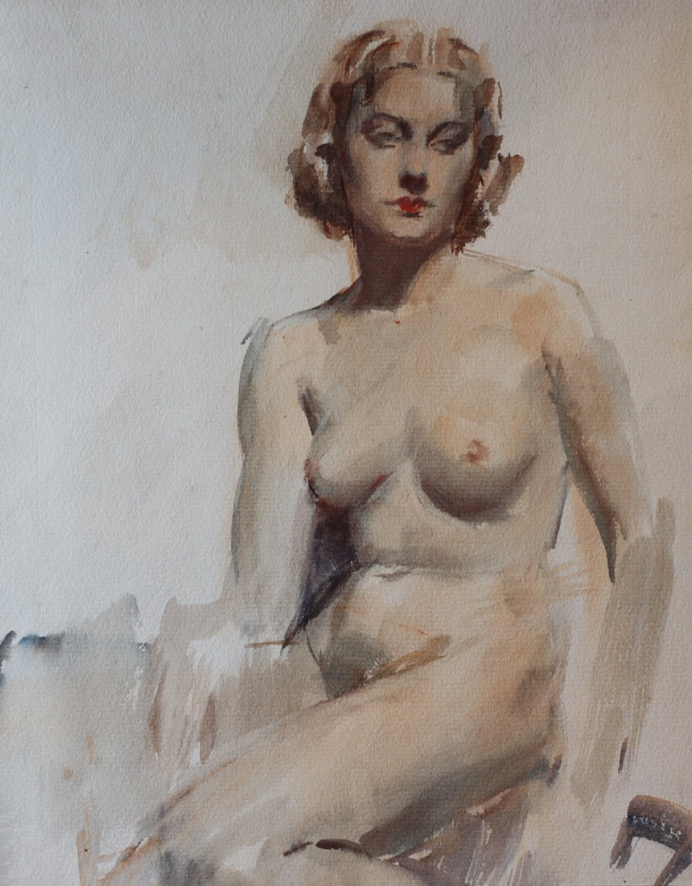 A 20th-century British School painting on paper depicting a seated female nude figure, presented within a wide cream mount and a dark oak moulded wooden frame. View III