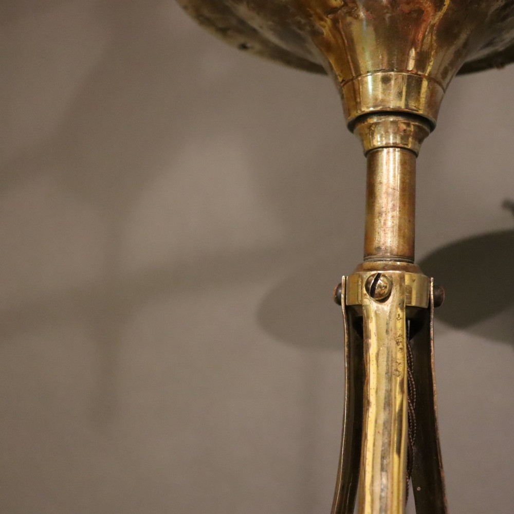 An antique Arts and Crafts brass ceiling fixture featuring a central hand-hammered canopy and three suspended drop pendant lights with frosted bell glass shades. View VI