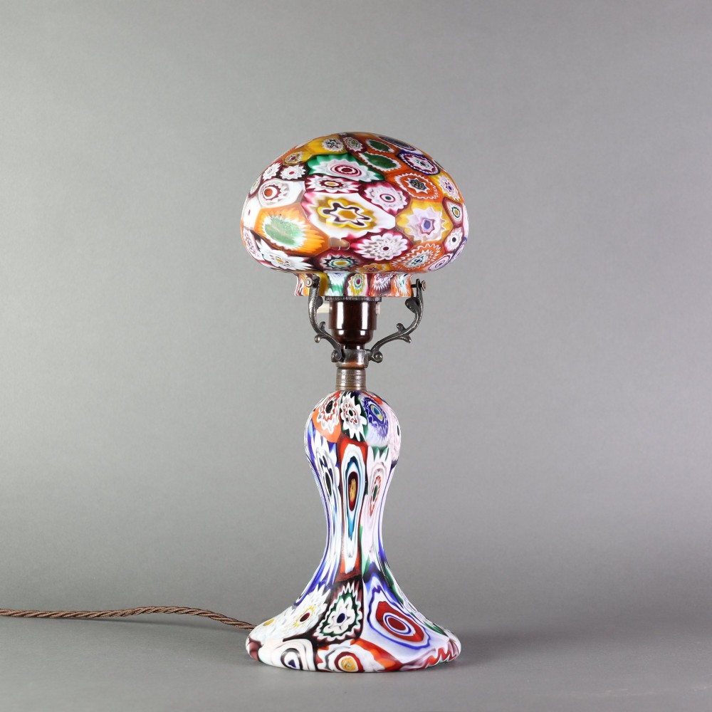 An Italian Art Deco millefiori glass table lamp featuring a colourful patterned mushroom shade and matching flared stem base with brass fittings. View II