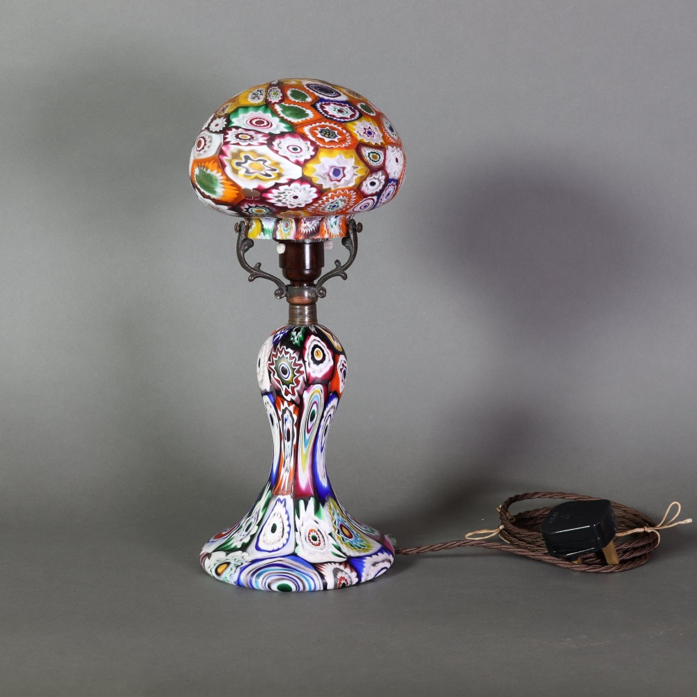 An Italian Art Deco millefiori glass table lamp featuring a colourful patterned mushroom shade and matching flared stem base with brass fittings. View III