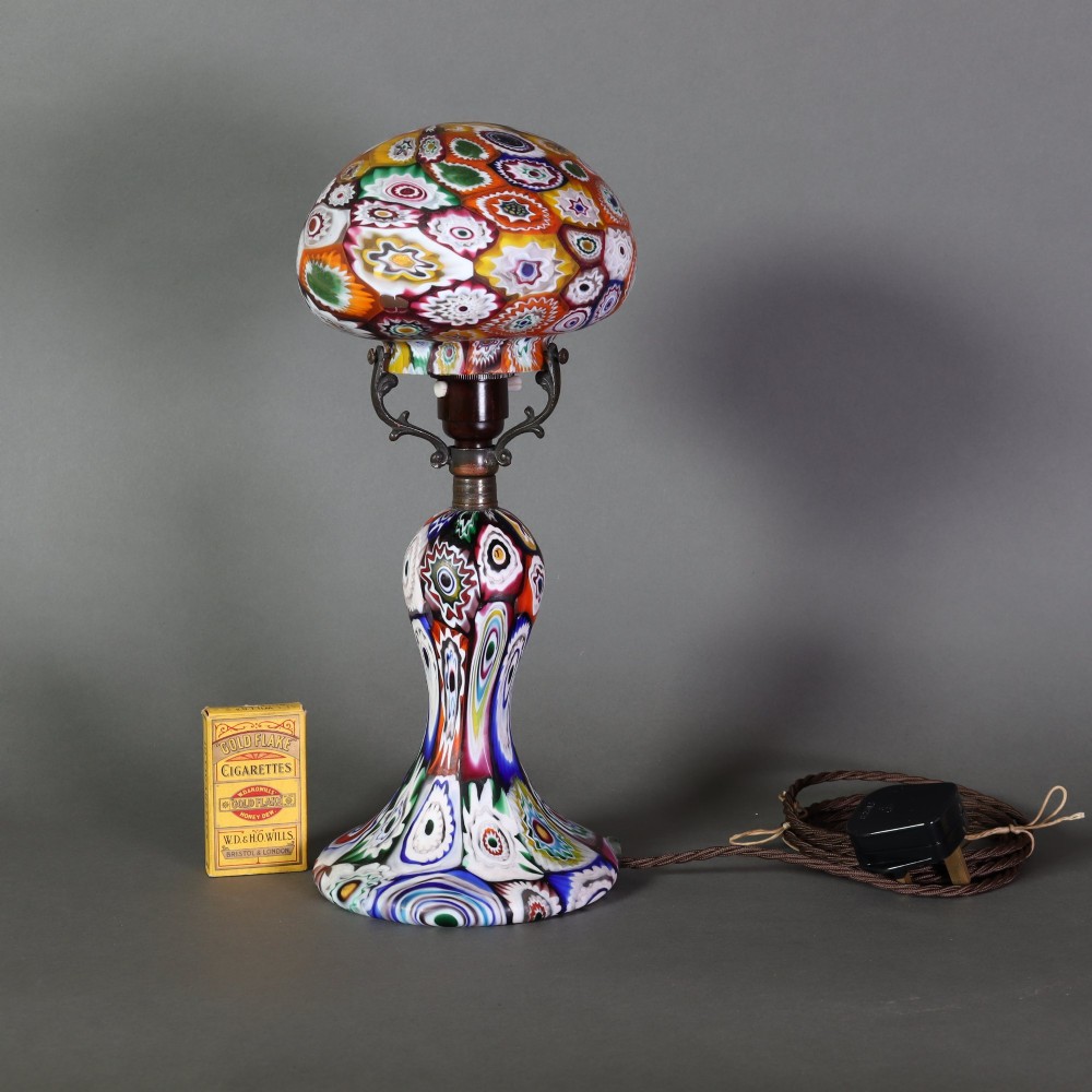 An Italian Art Deco millefiori glass table lamp featuring a colourful patterned mushroom shade and matching flared stem base with brass fittings. View IV