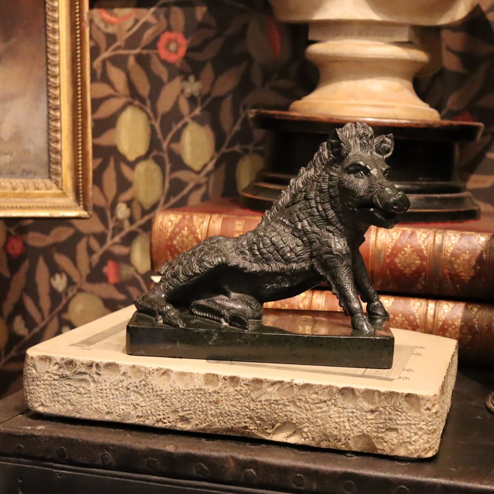A late nineteenth-century Italian Grand Tour sculpture of a seated wild boar carved from dark green serpentine marble set on a rectangular stone plinth. View III