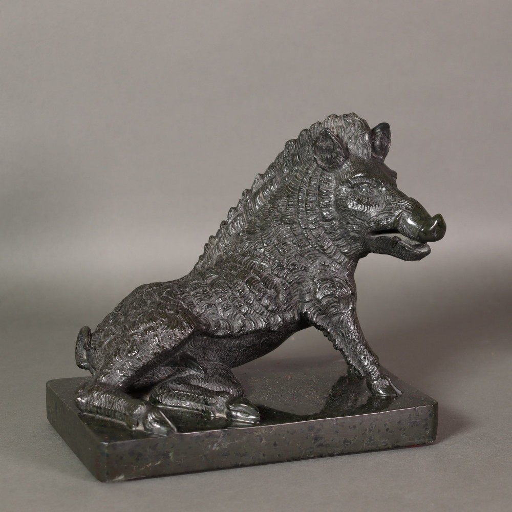 A late nineteenth-century Italian Grand Tour sculpture of a seated wild boar carved from dark green serpentine marble set on a rectangular stone plinth. View VI