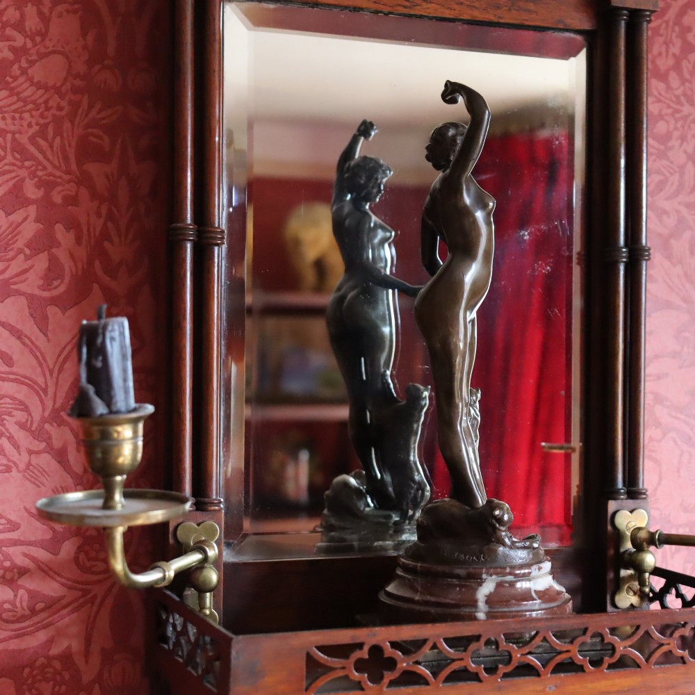 An Art Nouveau patinated bronze sculpture of a standing female figure with two cats mounted on a red marble base. View III