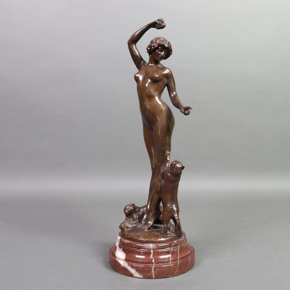 An Art Nouveau patinated bronze sculpture of a standing female figure with two cats mounted on a red marble base. View VII