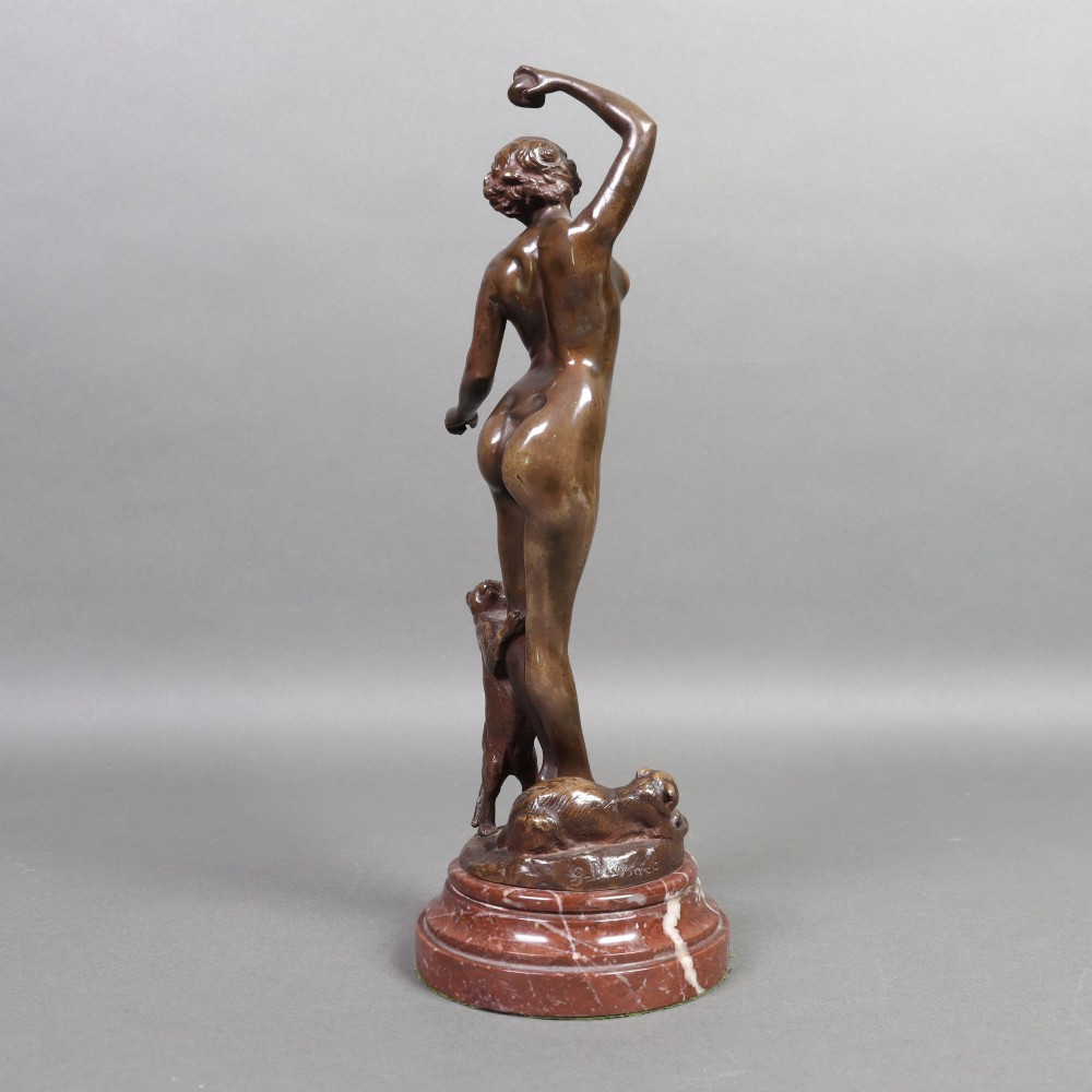 An Art Nouveau patinated bronze sculpture of a standing female figure with two cats mounted on a red marble base. View VIII