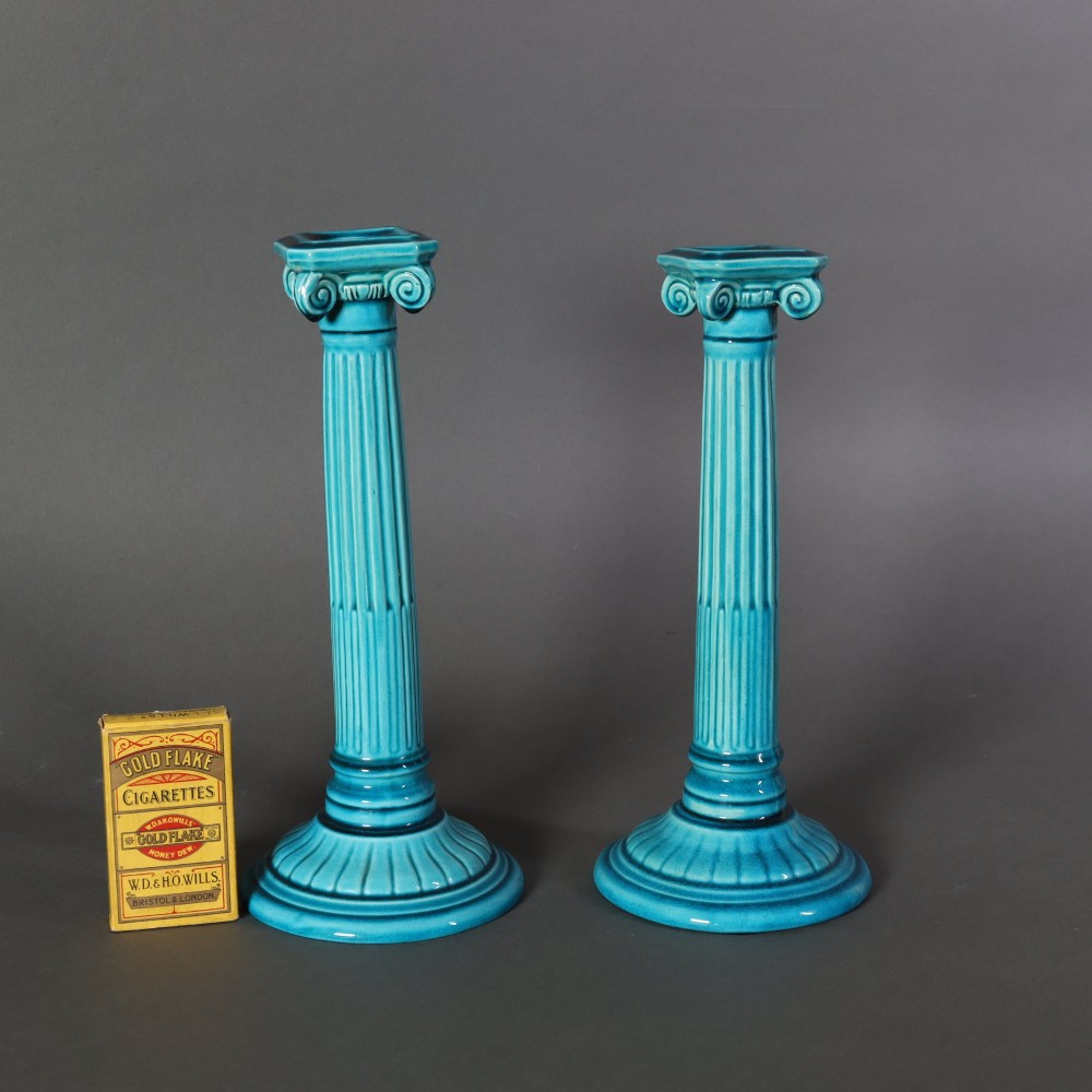 A matched pair of late 19th-century turquoise glazed ceramic candlesticks in the shape of classical fluted Ionic columns. View II