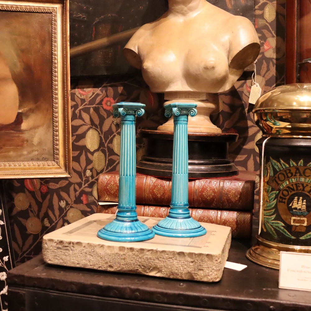 A matched pair of late 19th-century turquoise glazed ceramic candlesticks in the shape of classical fluted Ionic columns. View V