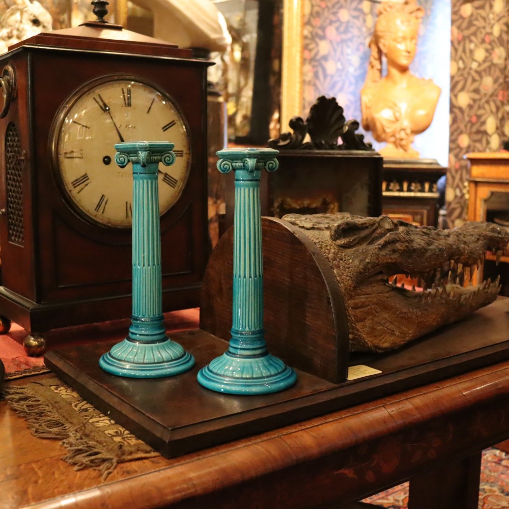 A matched pair of late 19th-century turquoise glazed ceramic candlesticks in the shape of classical fluted Ionic columns. View VI