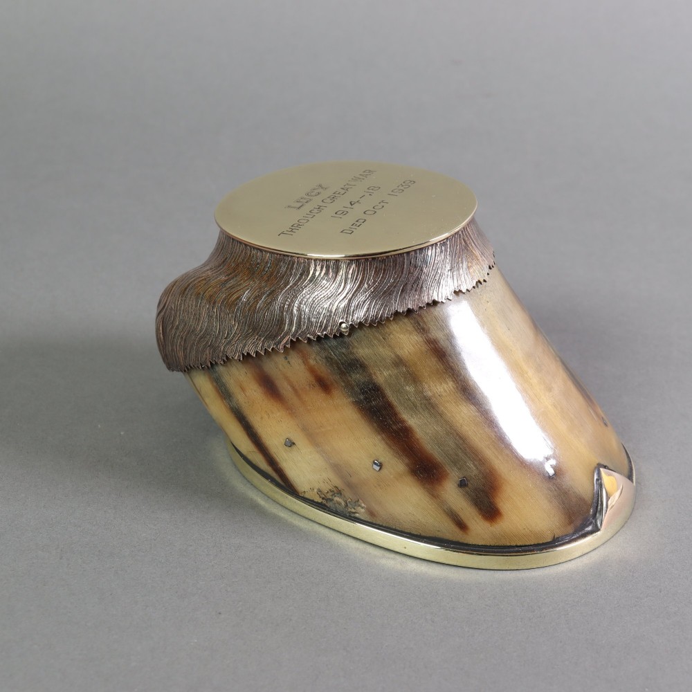 A preserved horse hoof mounted with an engraved brass top plate detailing military service dates and fitted with a polished brass rim around the base. View VI