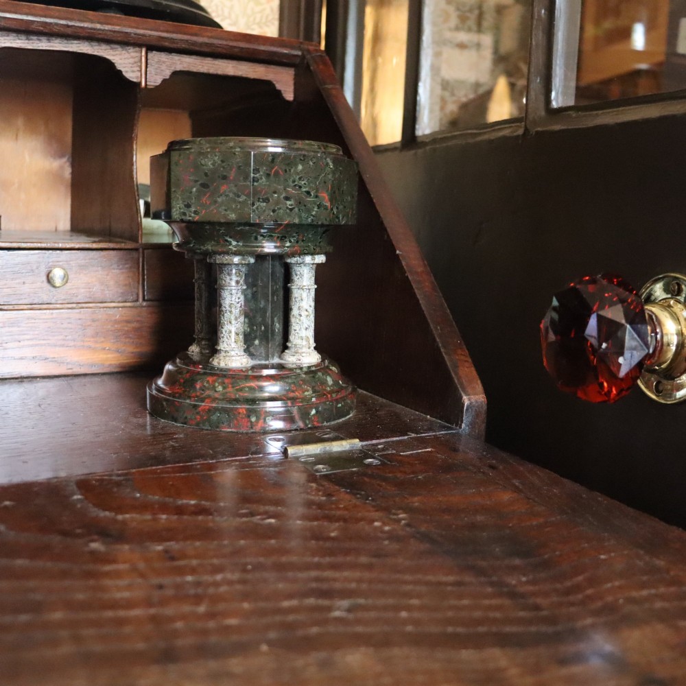 A late 19th-century carved Cornish serpentine stone model of an ecclesiastical font featuring an octagonal bowl supported by four turned columns on a circular base. View II