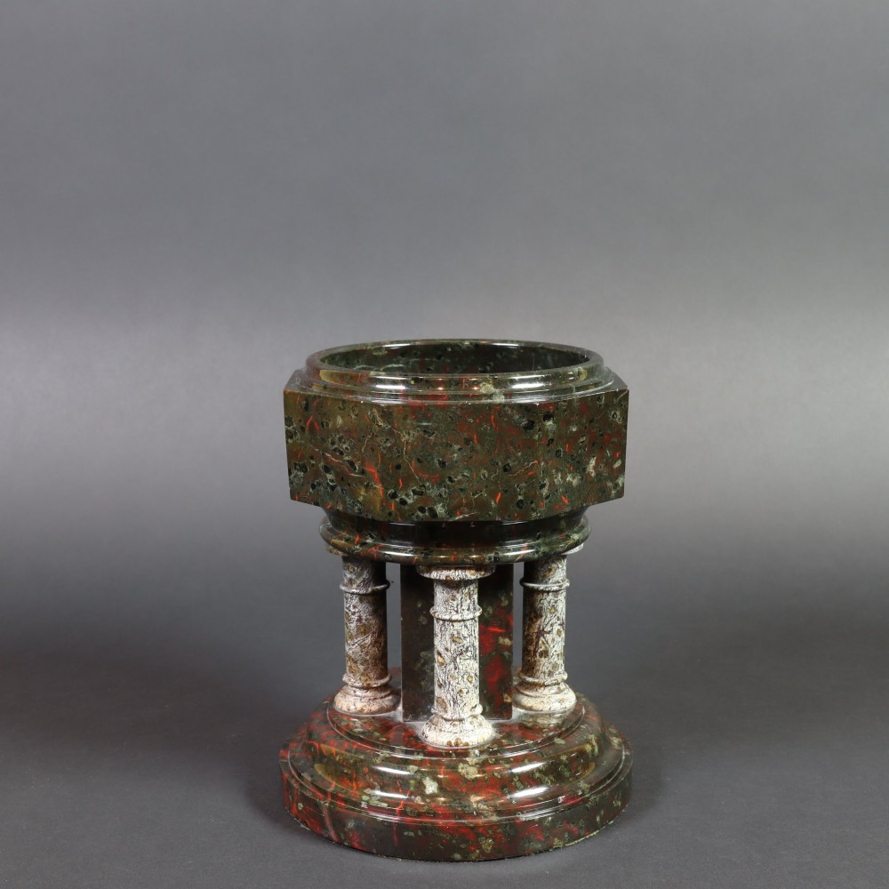A late 19th-century carved Cornish serpentine stone model of an ecclesiastical font featuring an octagonal bowl supported by four turned columns on a circular base.