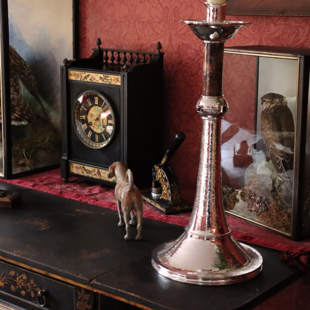An Aesthetic movement black slate mantel clock featuring hand-painted botanical panels, brass spindle gallery, and a circular dial with Roman numerals. View II