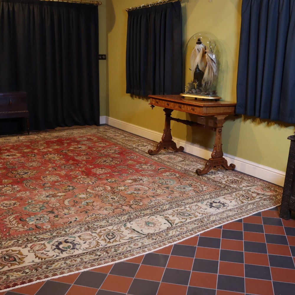 An antique hand-knotted red wool carpet featuring detailed floral palmettes and a light cream border. View II