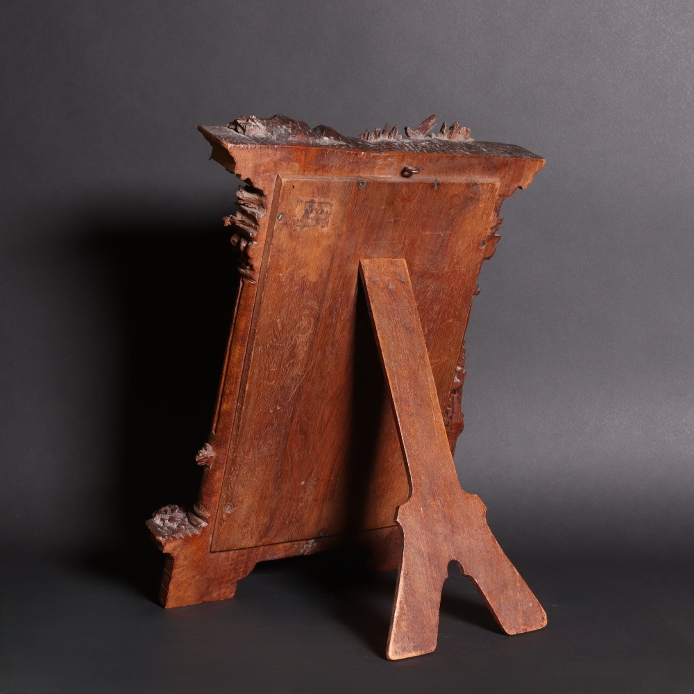 A late nineteenth-century Black Forest carved walnut table mirror featuring ornate architectural columns and botanical leaf carvings around the central rectangular mirror glass. View V