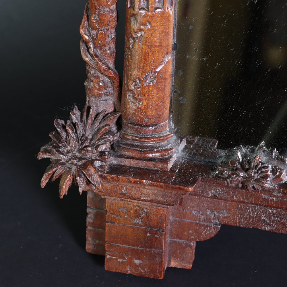 A late nineteenth-century Black Forest carved walnut table mirror featuring ornate architectural columns and botanical leaf carvings around the central rectangular mirror glass. View VII