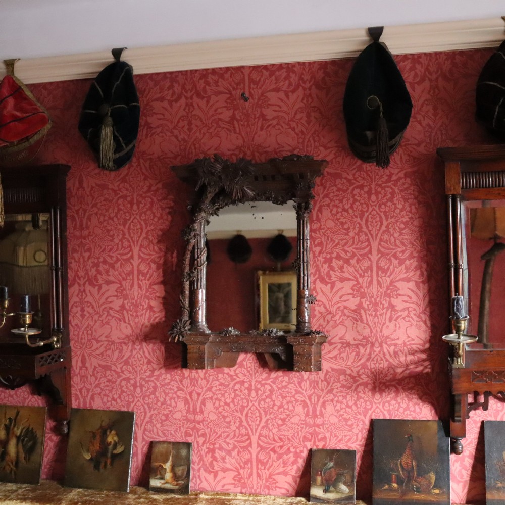 A late nineteenth-century Black Forest carved walnut table mirror featuring ornate architectural columns and botanical leaf carvings around the central rectangular mirror glass. View IX