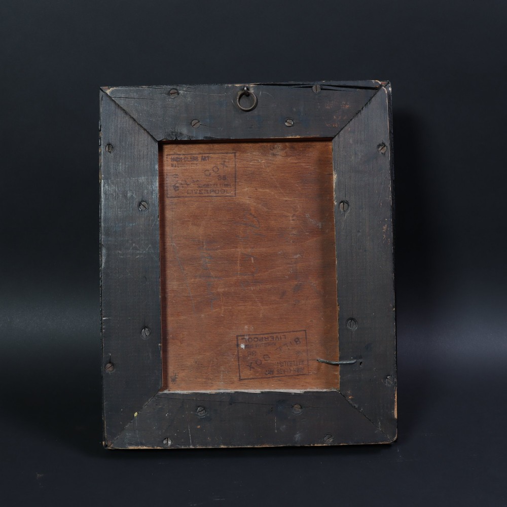 A Victorian taxidermy hawfinch perching on a mossy branch inside a glass-fronted ebonised picture frame case with a painted blue sky backdrop. View VI