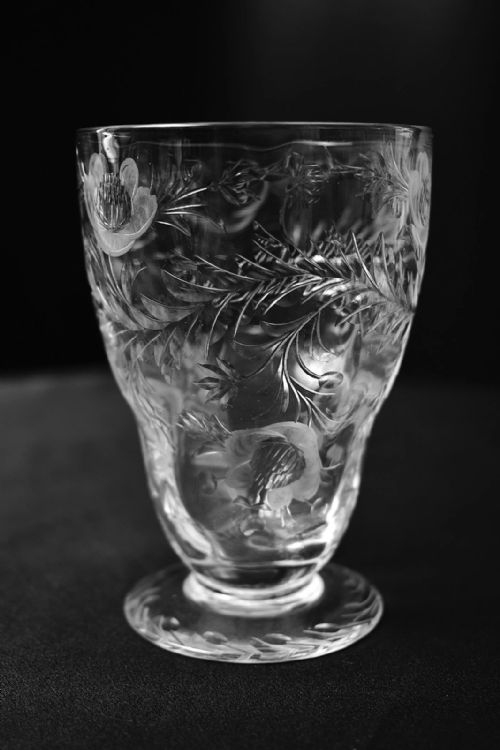 fig 5. A clear lead crystal drinking set comprising a large floral-engraved pitcher alongside three matching wine and tumbler glasses.