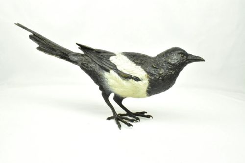 fig 1. An antique cold-painted bronze figure depicting a magpie with detailed black and white polychrome finish.