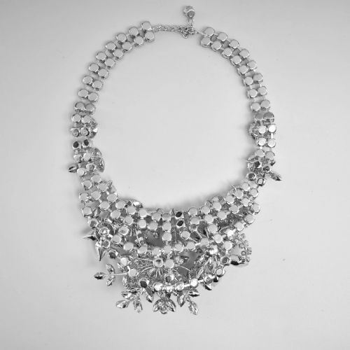 fig 4. A 1950s Christian Dior costume jewellery parure set featuring a necklace, brooch, and clip-on earrings with pink, green, and aurora borealis crystal floral clusters.