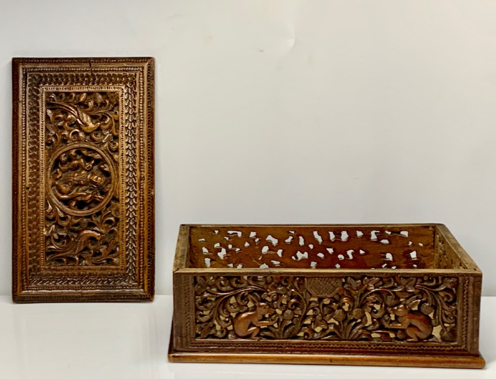 A nineteenth-century rectangular wooden box featuring intricate high-relief carvings of birds, foliage, and a central circular motif across the lid and sides. View XI