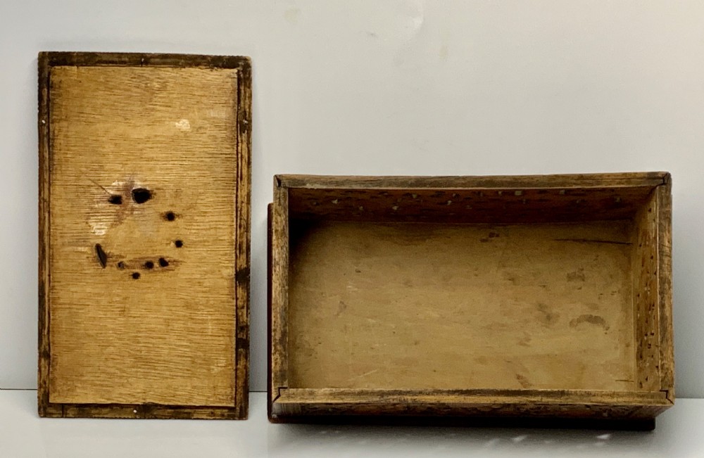 A nineteenth-century rectangular wooden box featuring intricate high-relief carvings of birds, foliage, and a central circular motif across the lid and sides. View XIII