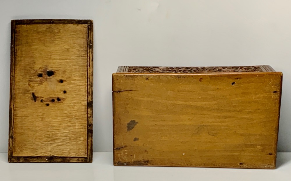 A nineteenth-century rectangular wooden box featuring intricate high-relief carvings of birds, foliage, and a central circular motif across the lid and sides. View XIV