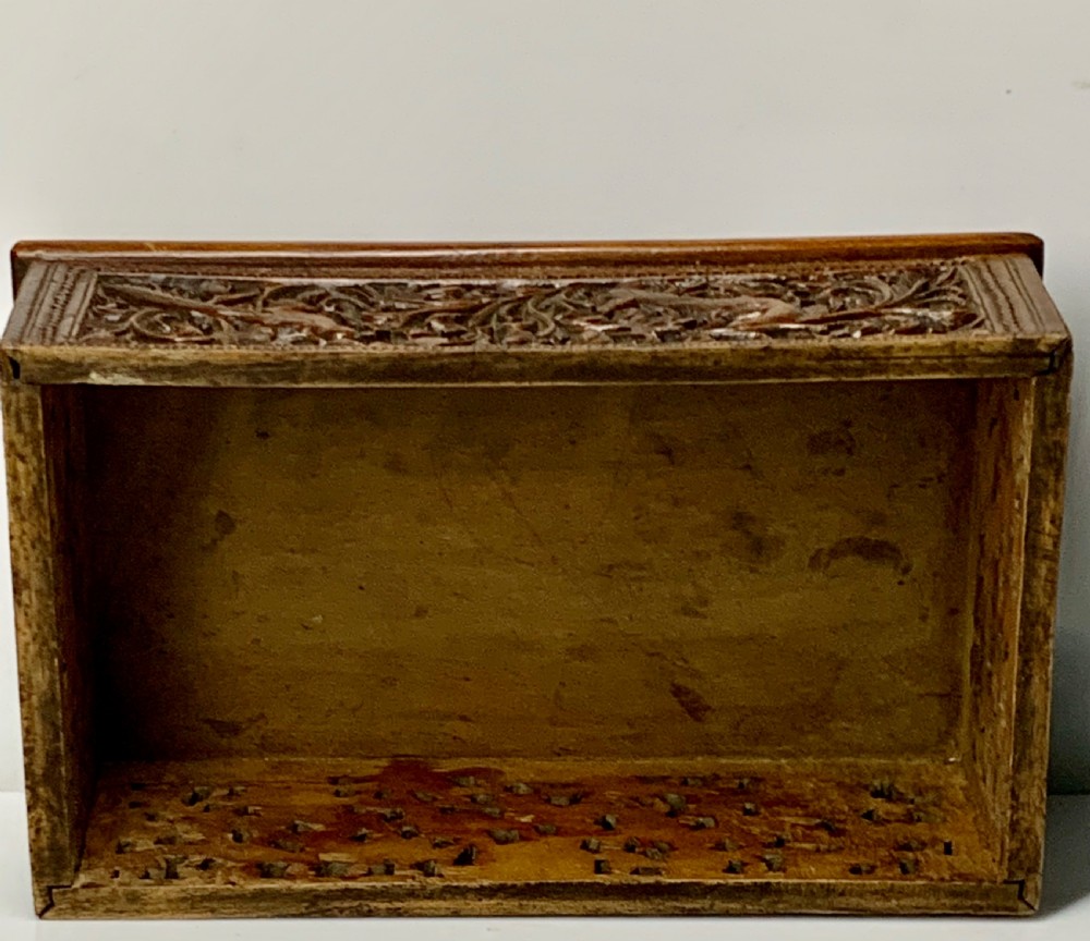 A nineteenth-century rectangular wooden box featuring intricate high-relief carvings of birds, foliage, and a central circular motif across the lid and sides. View XV
