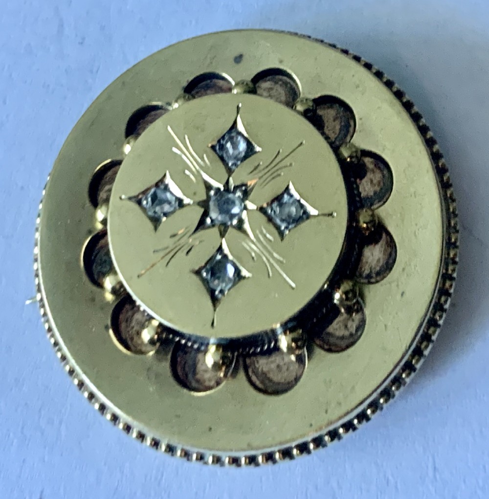 A Victorian Etruscan Diamond Set Brooch, of circular form