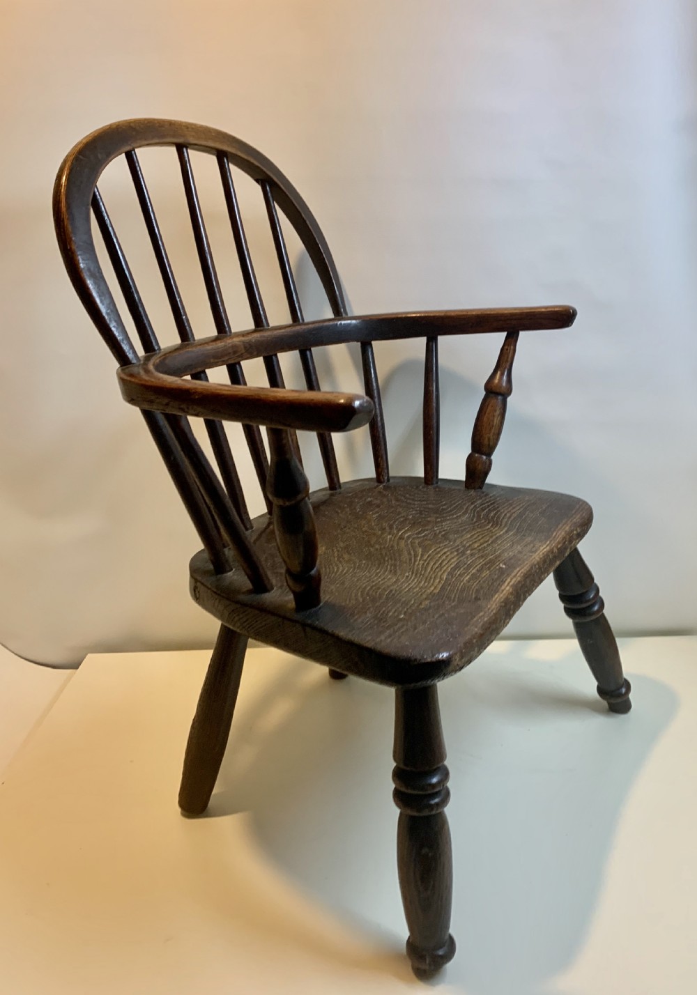 A Victorian Antique miniature elm Windsor chair, raised on turned legs View II