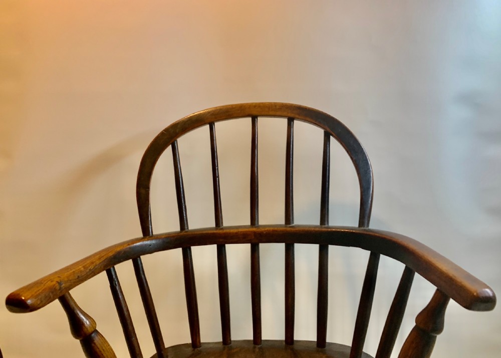A Victorian Antique miniature elm Windsor chair, raised on turned legs View VI