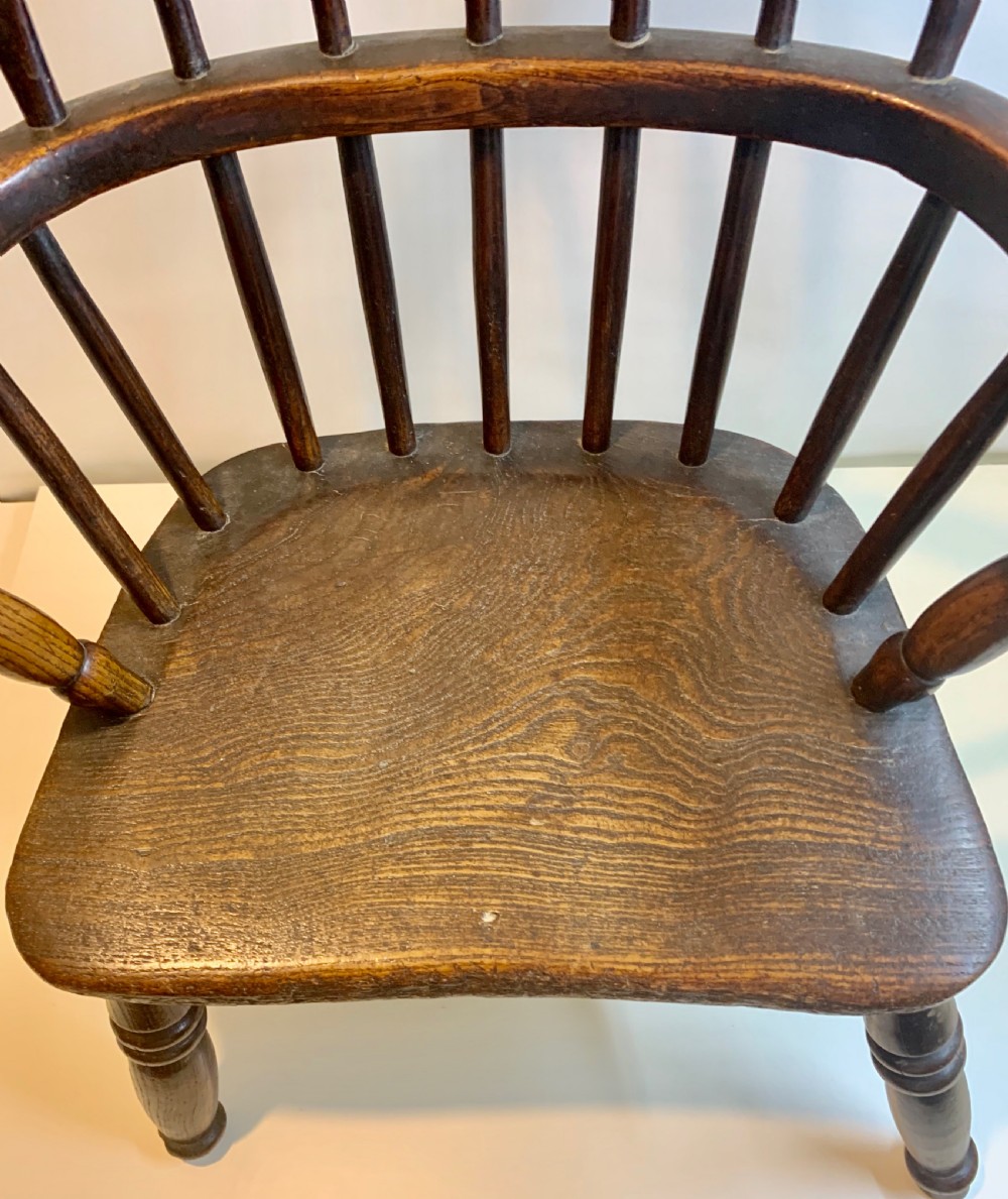 A Victorian Antique miniature elm Windsor chair, raised on turned legs View VII