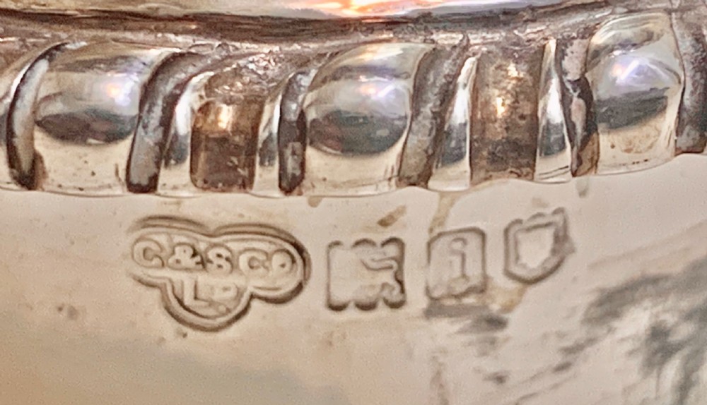 An urn-shaped Edwardian sterling silver sugar caster featuring chased ribbon bow swags and a pierced removable dome lid. View VII