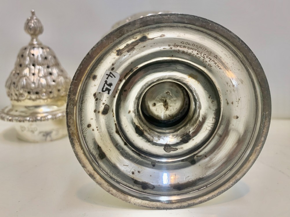 An urn-shaped Edwardian sterling silver sugar caster featuring chased ribbon bow swags and a pierced removable dome lid. View XI