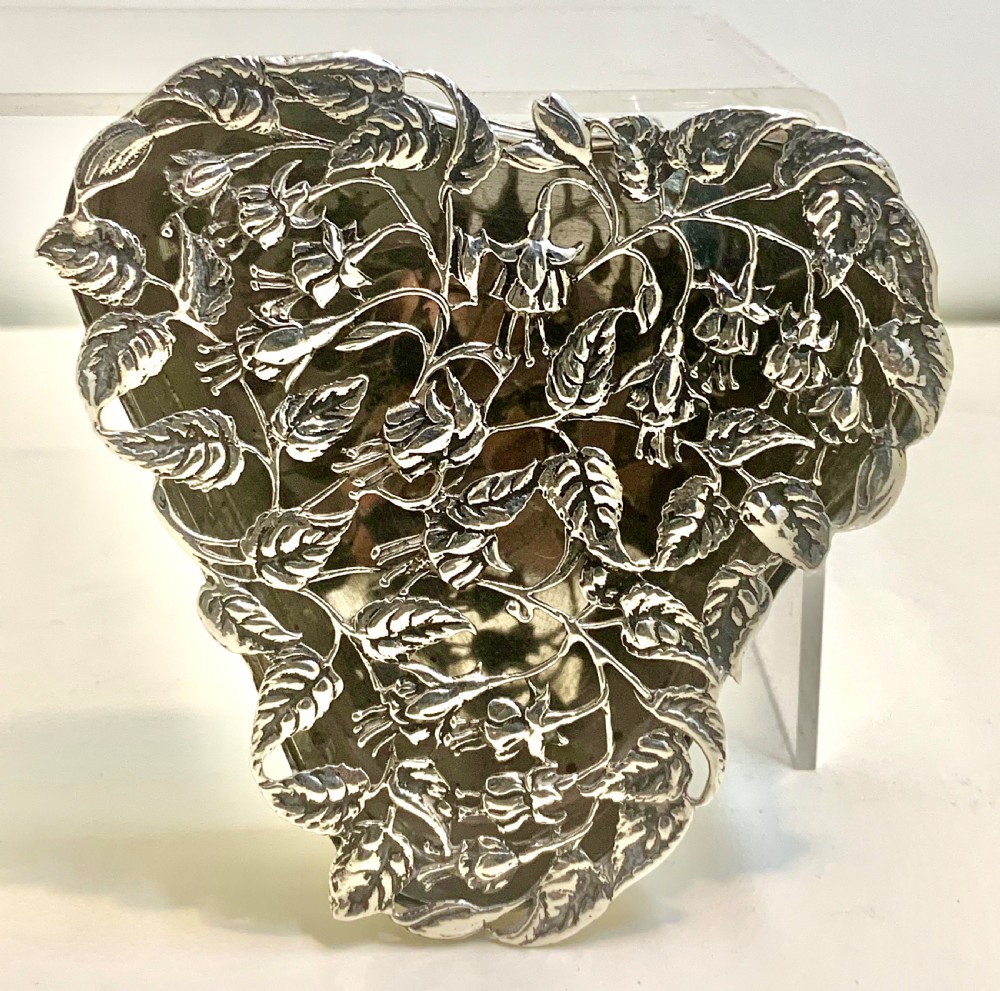 An Edwardian heart-shaped sterling silver trinket box featuring intricate pierced foliate openwork on the lid. View III