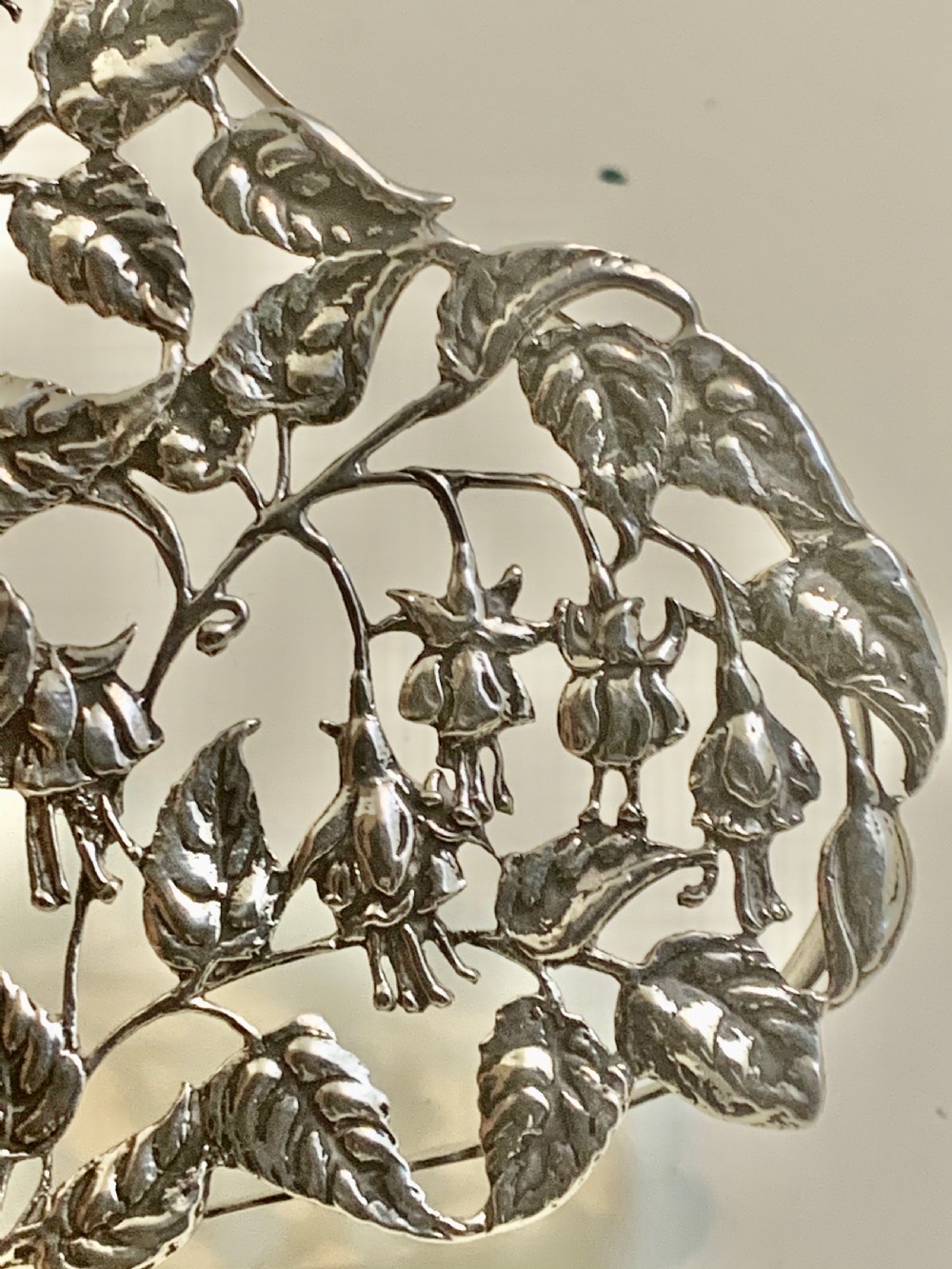 An Edwardian heart-shaped sterling silver trinket box featuring intricate pierced foliate openwork on the lid. View IX