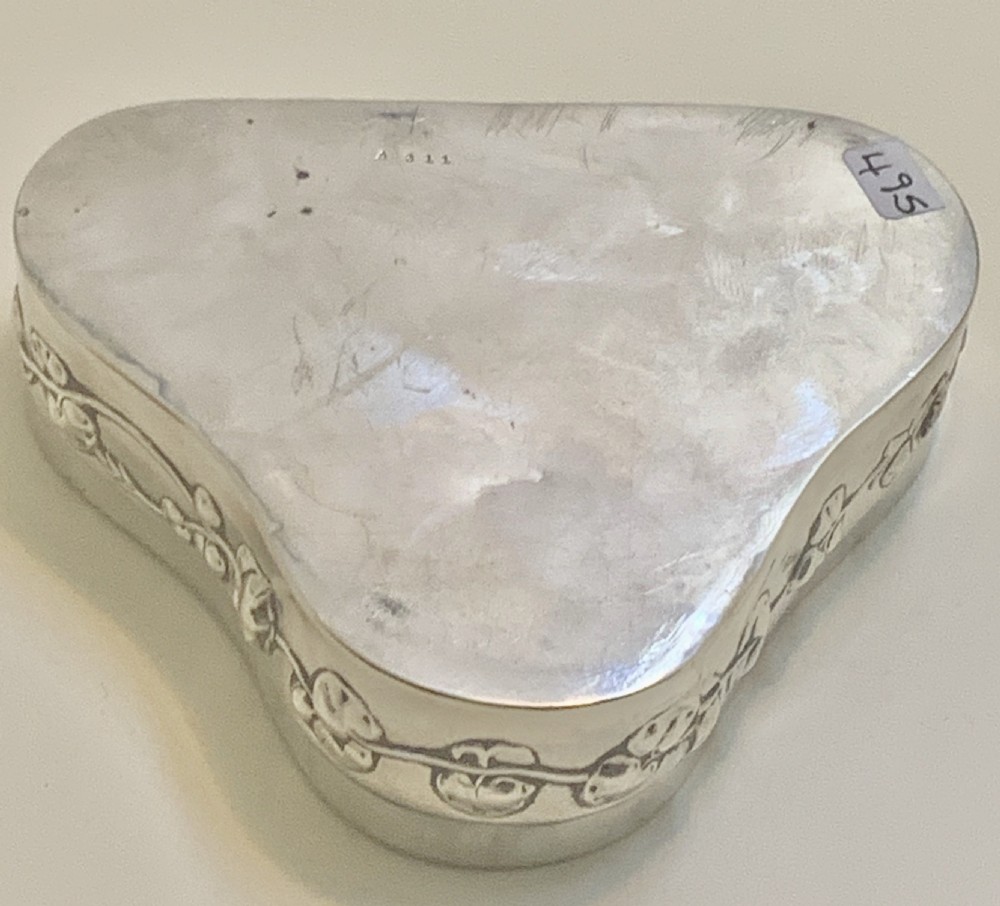 An Edwardian heart-shaped sterling silver trinket box featuring intricate pierced foliate openwork on the lid. View XII